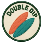Verdant Ride Double Dip badge: an embroidered patch, two crossed boards, cream field with a green border.