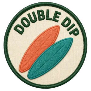 Verdant Ride Double Dip badge: an embroidered patch, two crossed boards, cream field with a green border.
