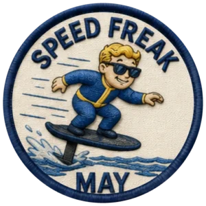Verdant Ride Speed Freak badge for May — embroidered navy-ringed patch showing a rider crouched low on an eFoil with spray and speed lines behind, and MAY on the banner below